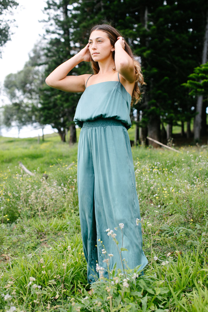 
                  
                    Effortless pull-on jumpsuit that features a smocked waist with a loose fit throughout the rest of the garment. Dyed to a muted teal blue.
                  
                