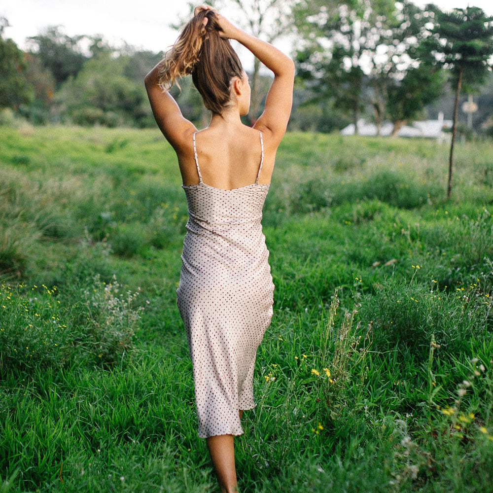 Natural mulberry silk midi slip dress. This slip dress showcases an imperfectly perfect casual polka-dot pattern.
